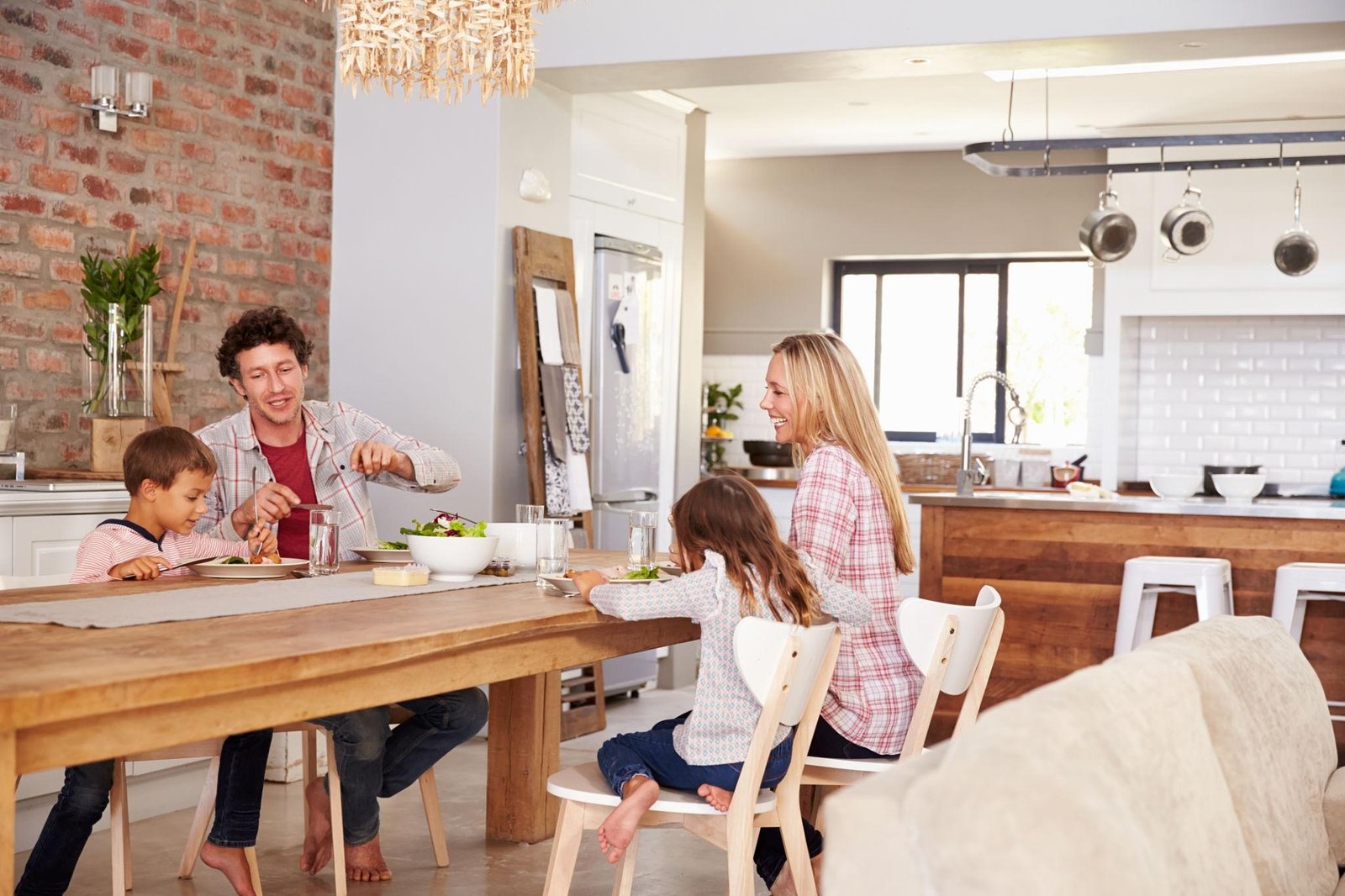 Family enjoying dinner around a modern wooden dining table